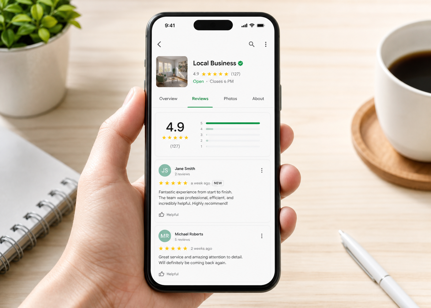 Smartphone showing a five-star Google business review page with a 4.9 rating and customer reviews